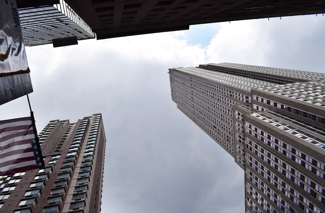 brown concrete building under white clouds during daytime