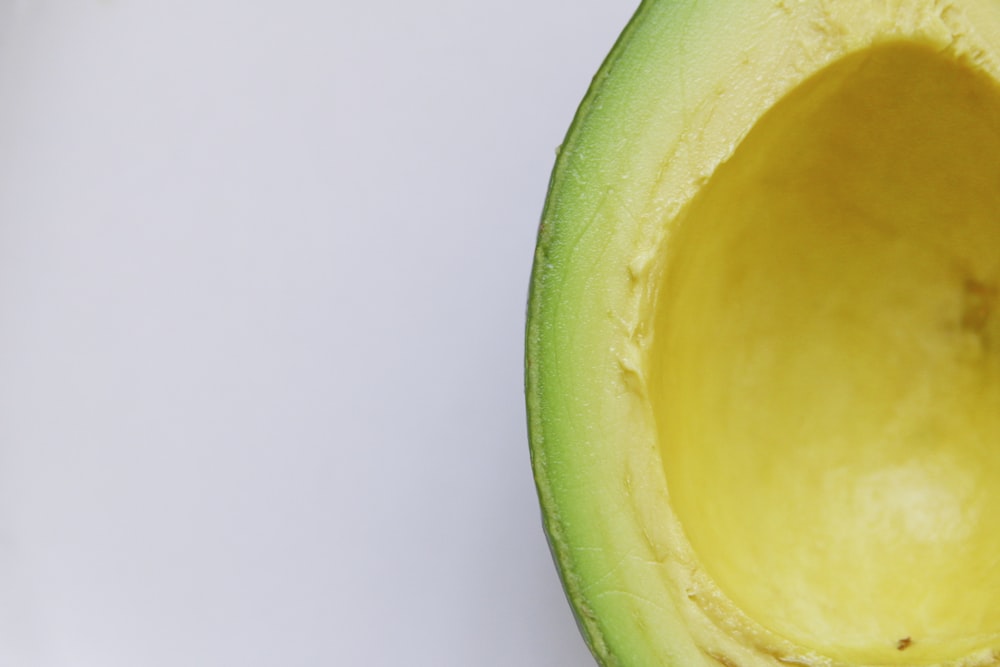 sliced avocado against white background