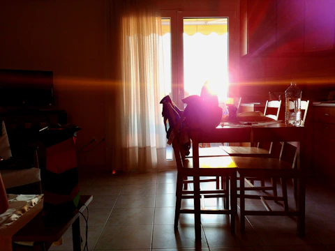 A warm family discussion around the kitchen table during afternoon light.