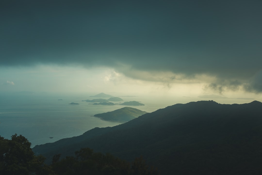 aerial photography of mountain near body of water