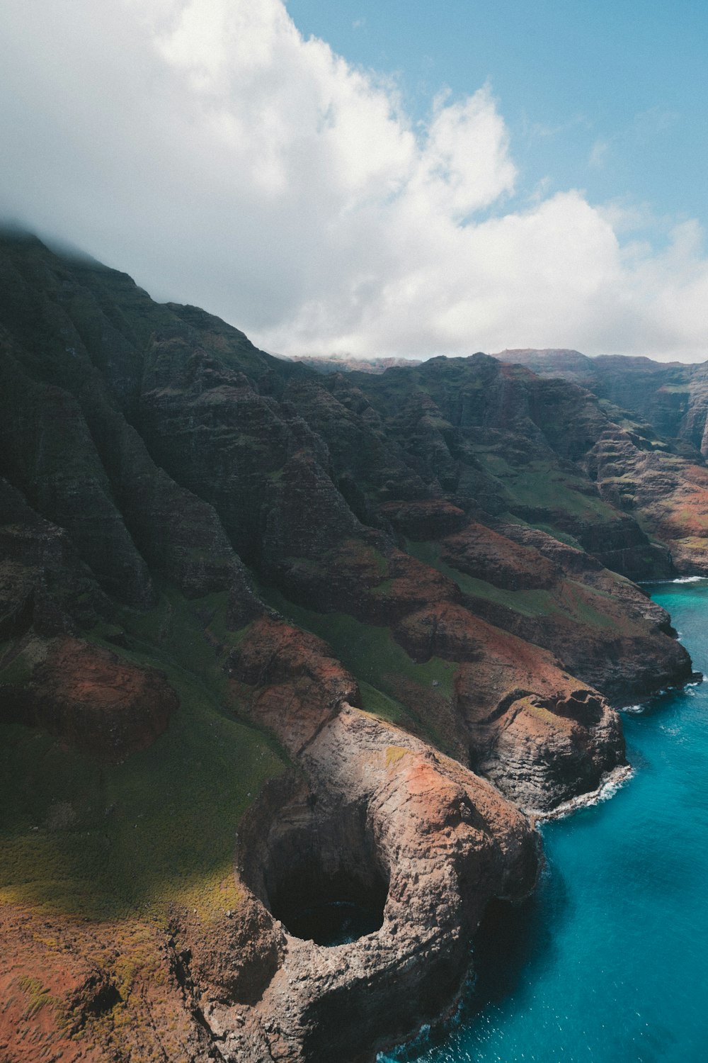 aerial photography of mountains near body of water