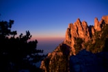 Sunset casting warm hues over jagged mountain peaks.