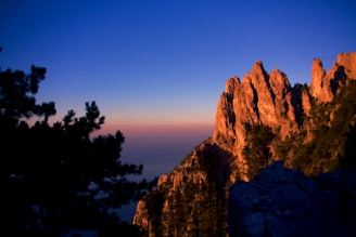 Sunset casting warm light over rugged mountain peaks.