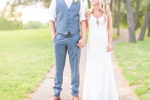Couple holding hands at their wedding