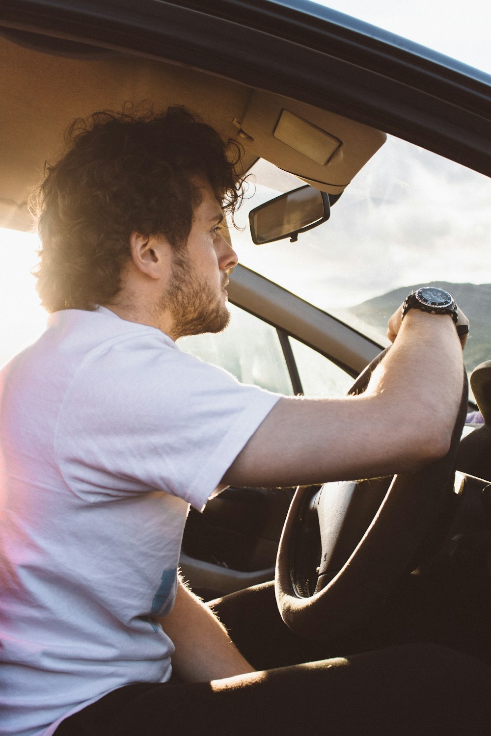 man holding steering wheel