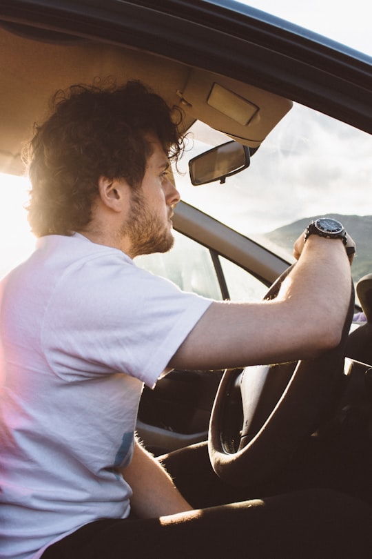 man holding steering wheel in Loch Lochy United Kingdom