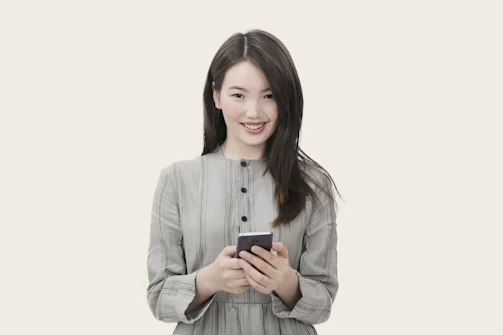 User holding a smartphone with droidrooter app open, smiling confidently.