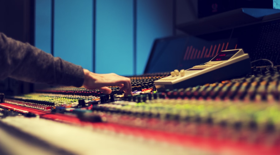 closeup photography of man operating audio mixer