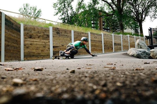 man riding longboard on road in Edmonton Canada