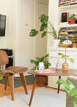 brown wooden table and chair beside bookshelf