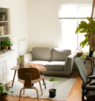 gray fabric loveseat near brown wooden table