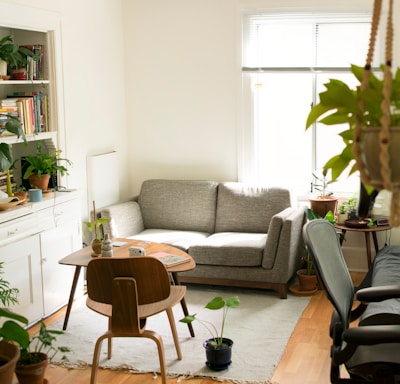 gray fabric loveseat near brown wooden table