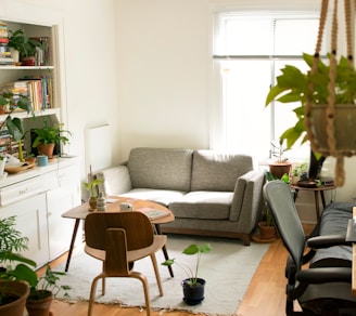 gray fabric loveseat near brown wooden table