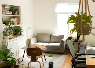 gray fabric loveseat near brown wooden table