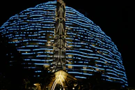 Night shot of a futuristic building facade lit with dynamic LED patterns in Monterrey.