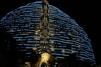 Futuristic office building illuminated with blue neon lights at dusk