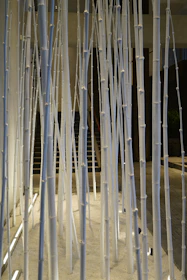 A serene installation piece blending natural wood and soft lighting in a gallery space.