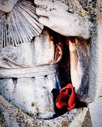 A gentle hand cleaning a weathered memorial with a soft brush.