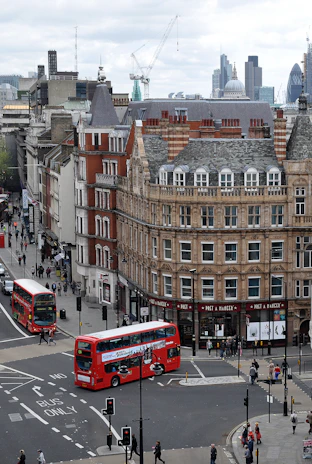 aerial photography of buses on road between European styled building