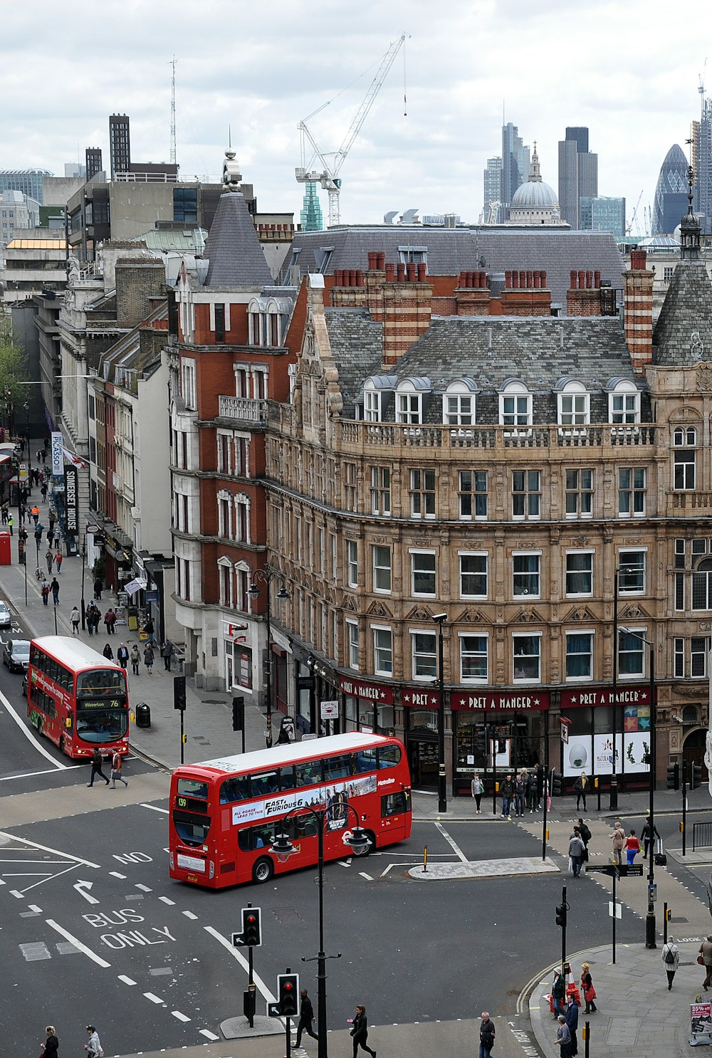 aerial photography of buses on road between European styled building