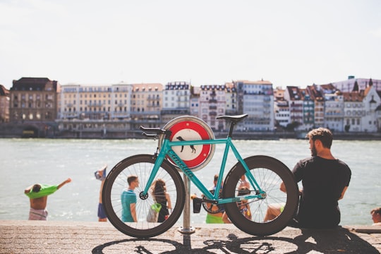 teal road bicycle parking near body of wat in Basel Switzerland