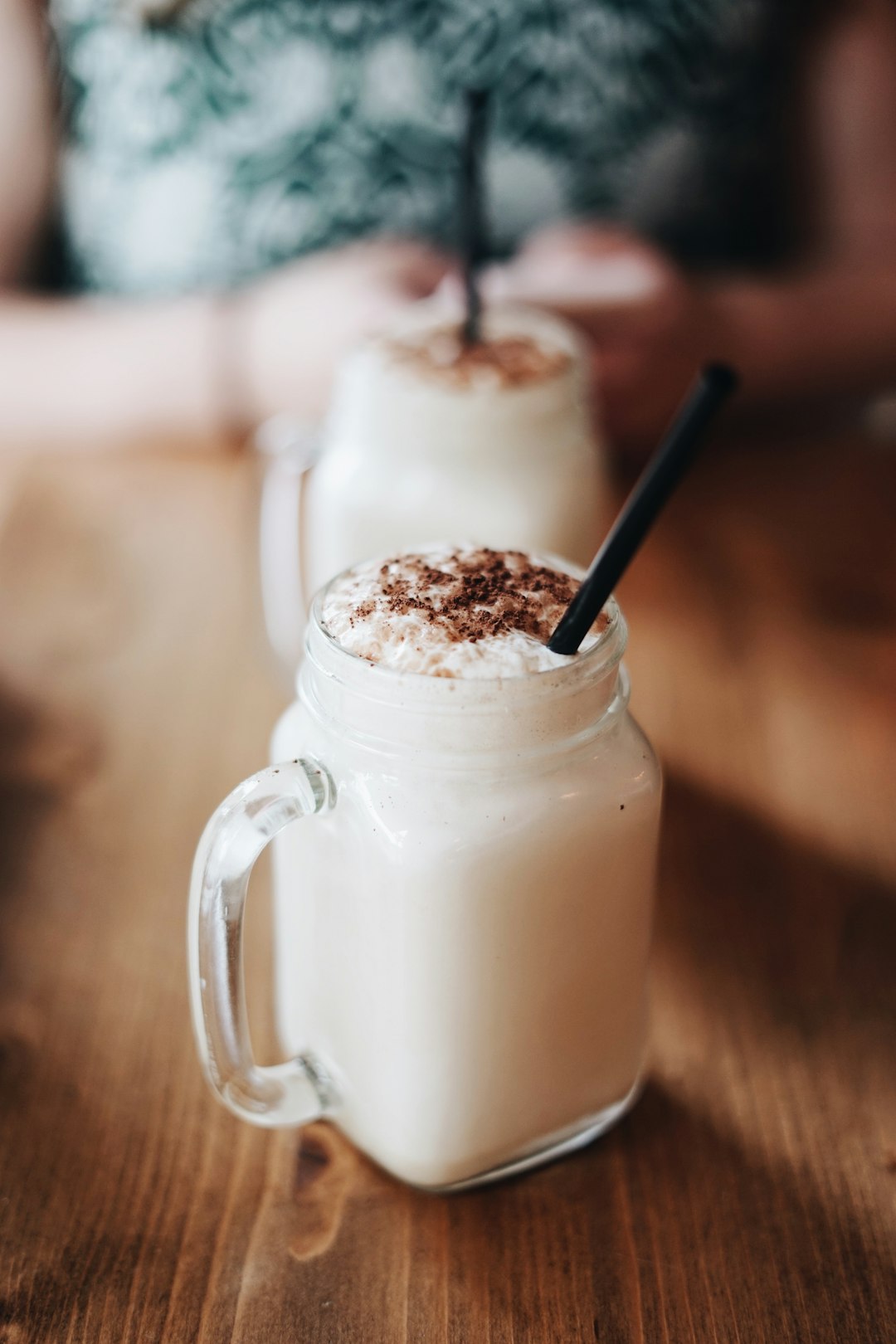 jar with handle filled with cream and chocolate on table