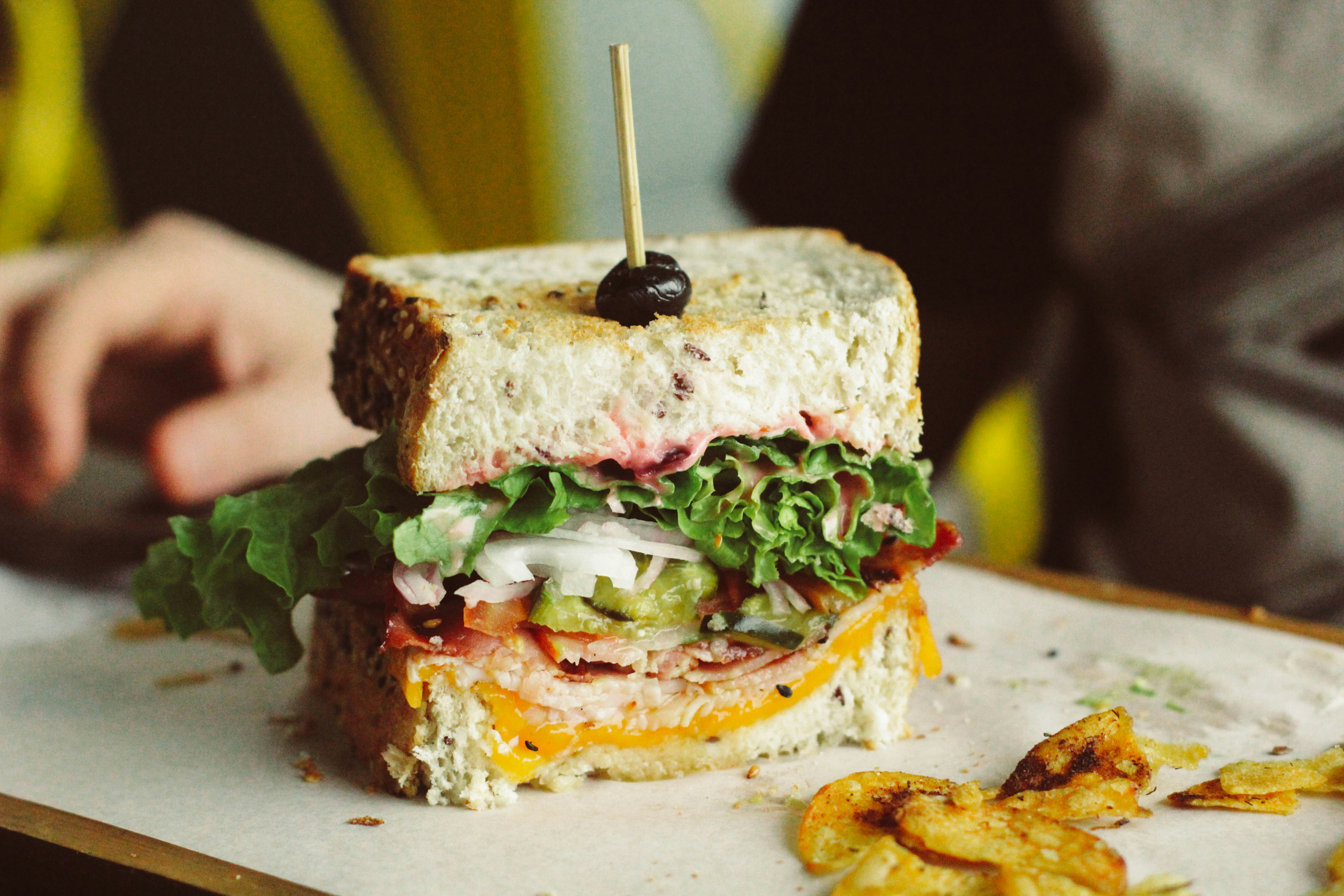 macro photography of sliced sandwich with vegetable