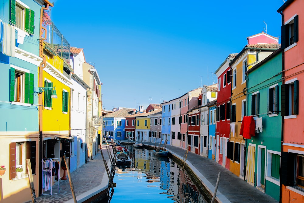 water canal between assorted-color buildings at daytime