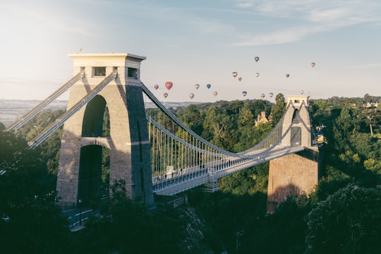 hot air balloons flying above trees in Clifton Suspension Bridge United Kingdom