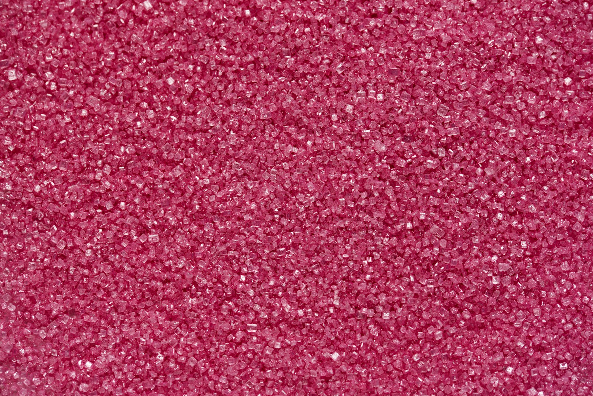 a close up of a pink glitter background