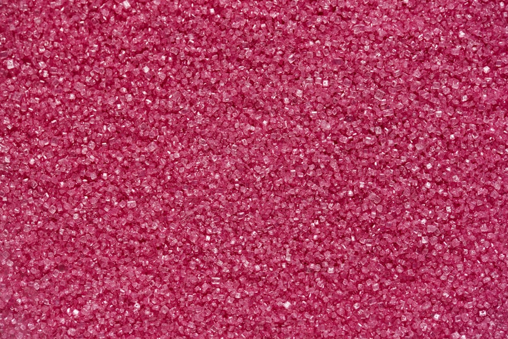 a close up of a pink glitter background