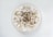 A bowl filled with milk and topped with various grains, seeds, and nuts. The mixture appears to include oats, pumpkin seeds, and possibly pieces of dried fruit.