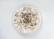 A warm bowl of sprouted multi millets malt topped with colorful dry fruits and nuts.