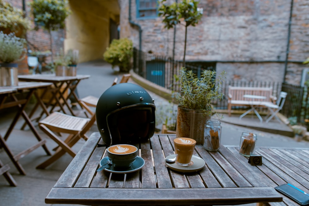 espresso filled cups near the motorcycle helme