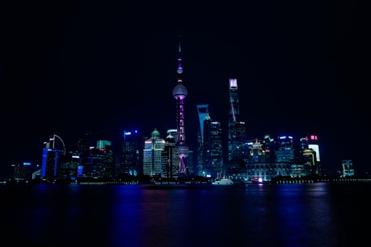 city lights reflection on water in 上海市人民英雄纪念塔 China