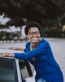 woman beside white vehicle during daytime