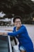 woman beside white vehicle during daytime