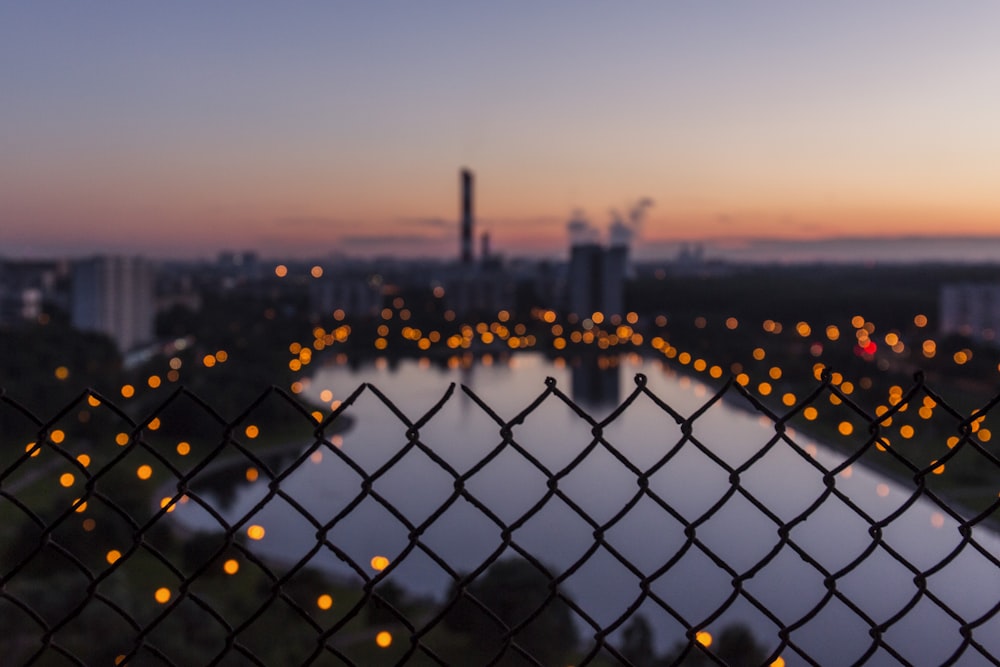 shallow focus photography of cyclone fence