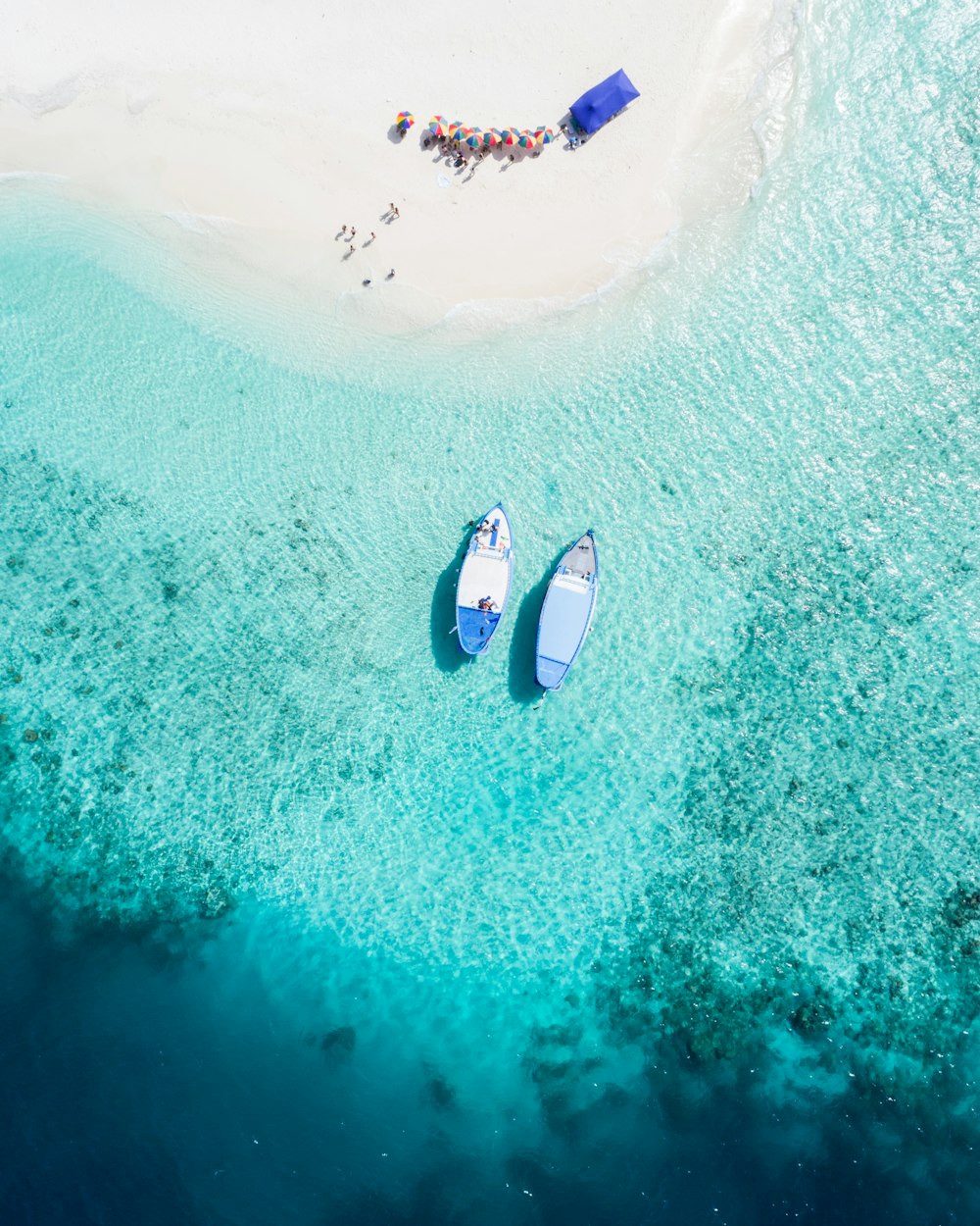 aerial view of two blue boats