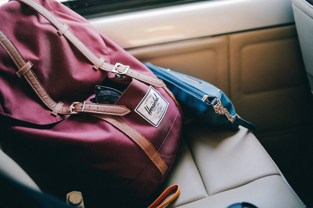 maroon Herschel bag inside car, Backpack purse on seat