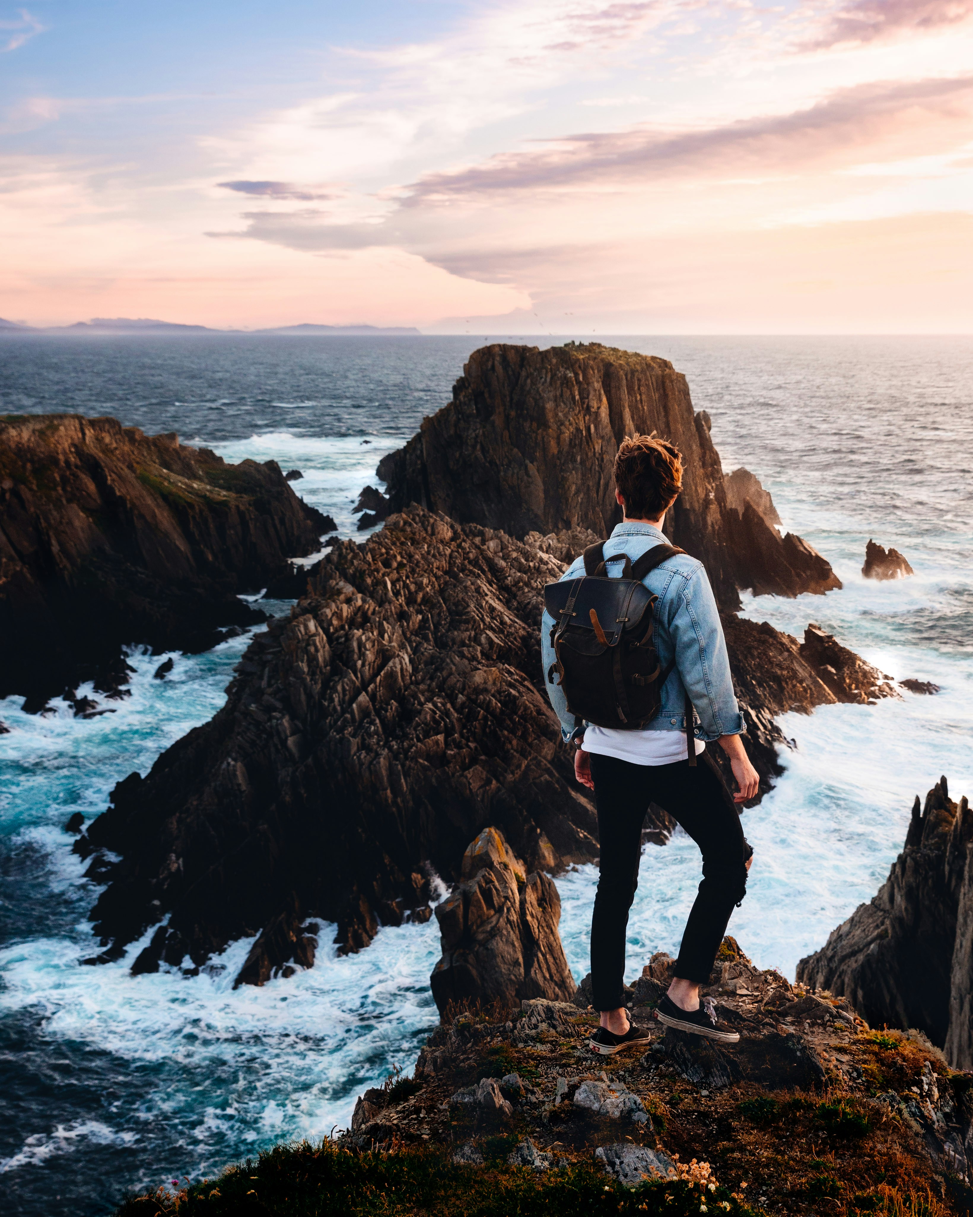 great photo recipe,how to photograph after hiking towards the roaring ocean with no idea what was ahead of us, this view opened up before our eyes.; man standing near cliff looking at body of water during daytime