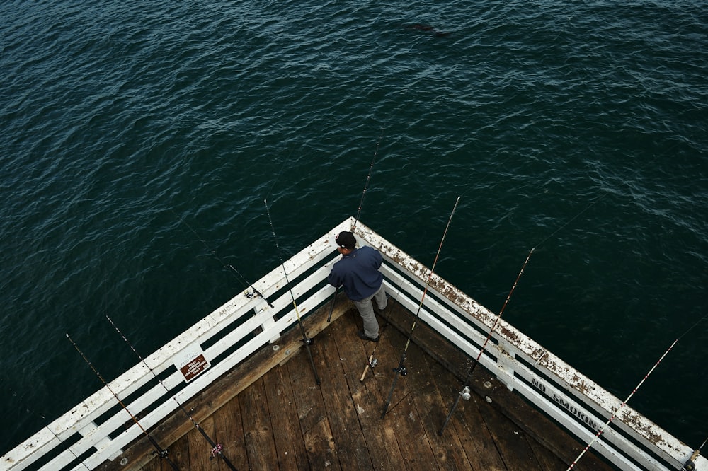 homme à côté de la pêche sur le quai