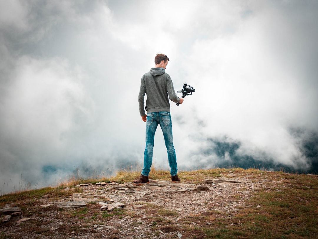 man holding camera with stabilizer while standing