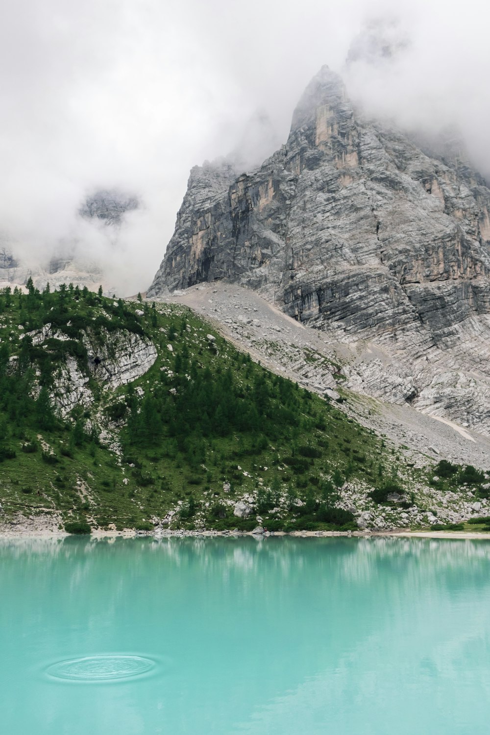 body of water near rock formation photography