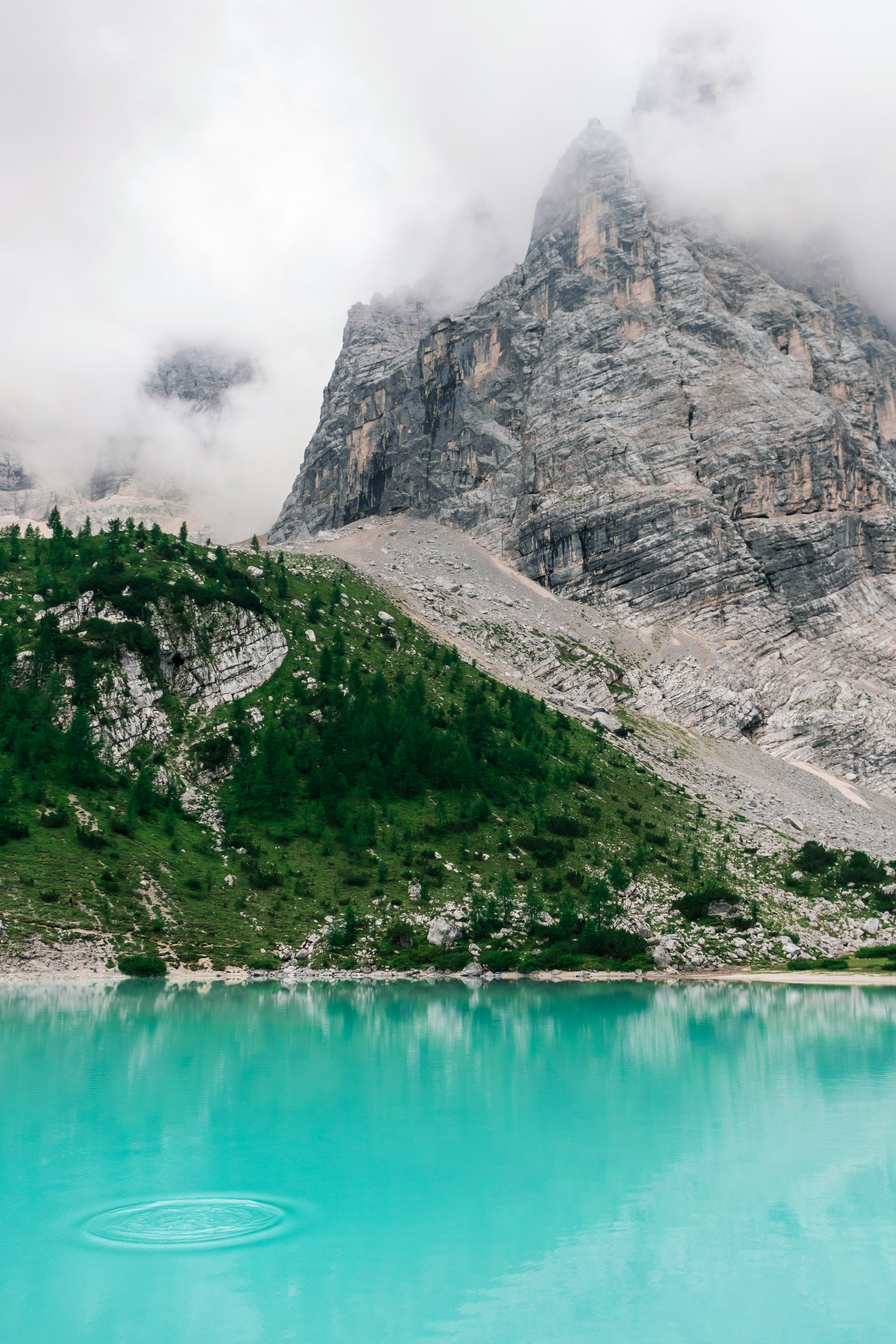 body of water near rock formation photography