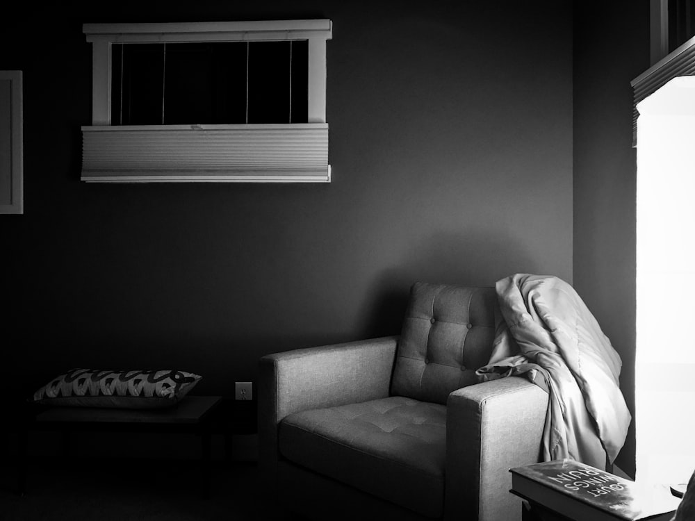 grayscale photography of sofa chair on corner
