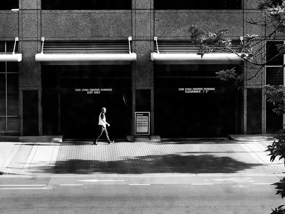 person walking in front of building