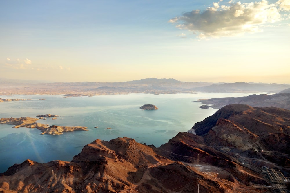 aerial view of body of water surrounded with mountains