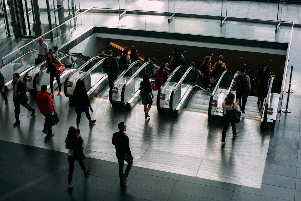 people walking towards the escalators