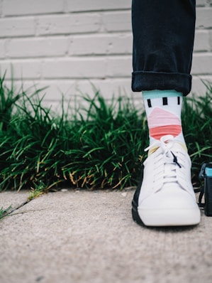 person wearing black pants and white sneaker